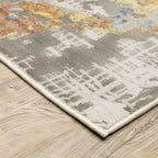 Modern abstract rug with distressed grey, gold, and blue tones featuring architectural patterns