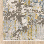 Modern abstract rug with distressed grey, gold, and blue tones featuring architectural patterns