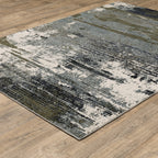 Abstract distressed area rug with grey, olive, and cream mottled texture pattern