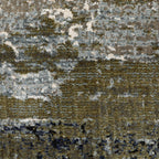 Abstract distressed area rug with grey, olive, and cream mottled texture pattern