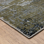 Abstract distressed area rug with grey, olive, and cream mottled texture pattern