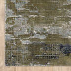 Abstract distressed area rug with grey, olive, and cream mottled texture pattern