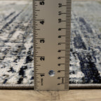 Abstract distressed area rug with grey, olive, and cream mottled texture pattern