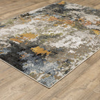 Modern abstract area rug with distressed gold, gray, and blue speckled pattern