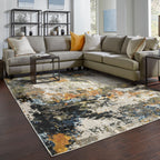 Modern abstract area rug with distressed gold, gray, and blue speckled pattern