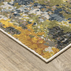 Modern abstract area rug with distressed gold, gray, and blue speckled pattern