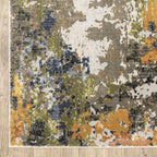 Modern abstract area rug with distressed gold, gray, and blue speckled pattern