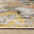 Modern abstract area rug with distressed gold, gray, and blue speckled pattern