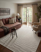 Beige and taupe striped area rug with geometric block pattern design