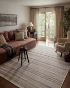 Neutral striped outdoor rug in beige and grey tones on patio
