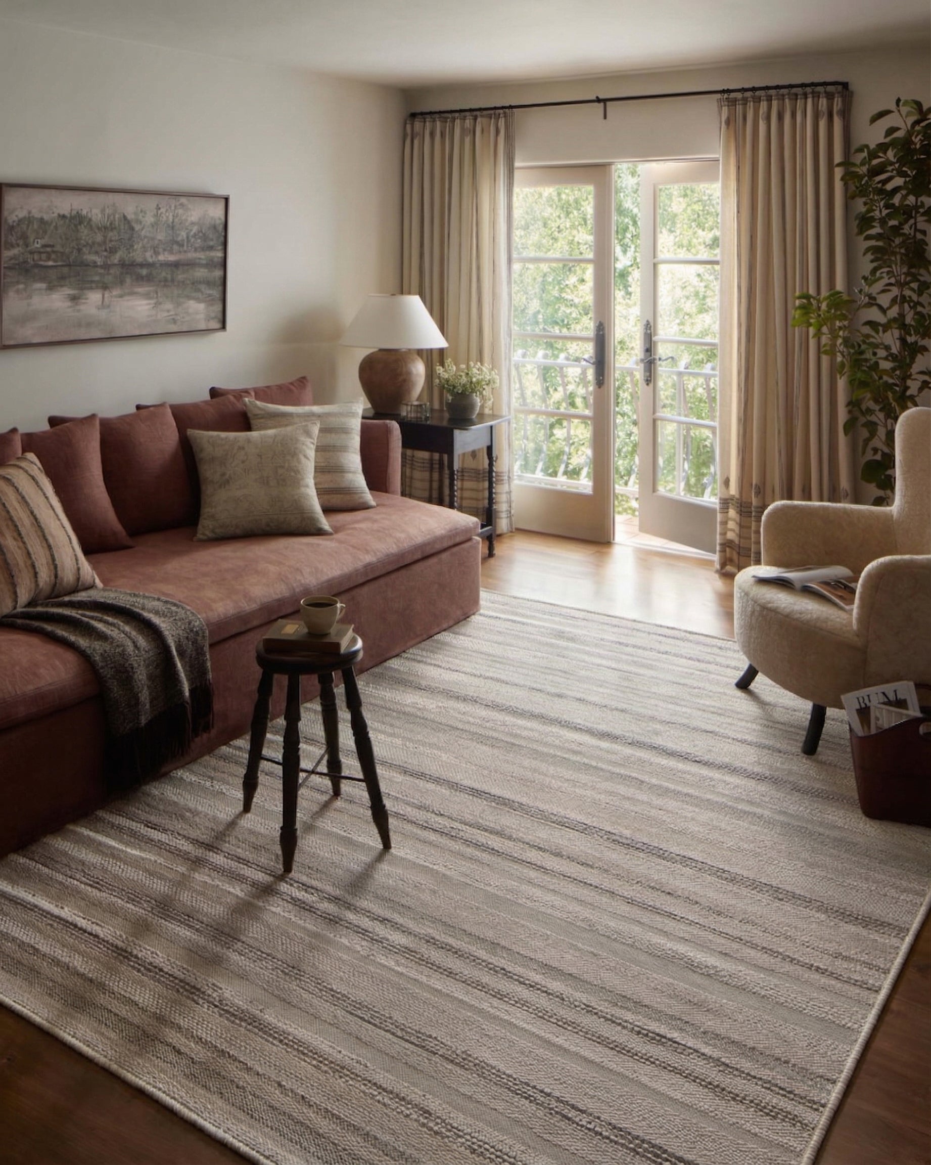 Neutral striped outdoor rug in beige and grey tones on patio