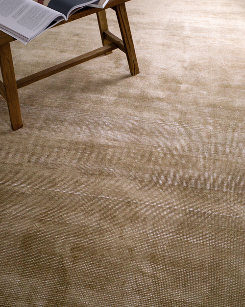 Beige textured rug with subtle horizontal striations and soft woven finish