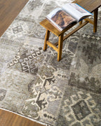 Vintage patchwork rug with geometric patterns in gray and cream tones