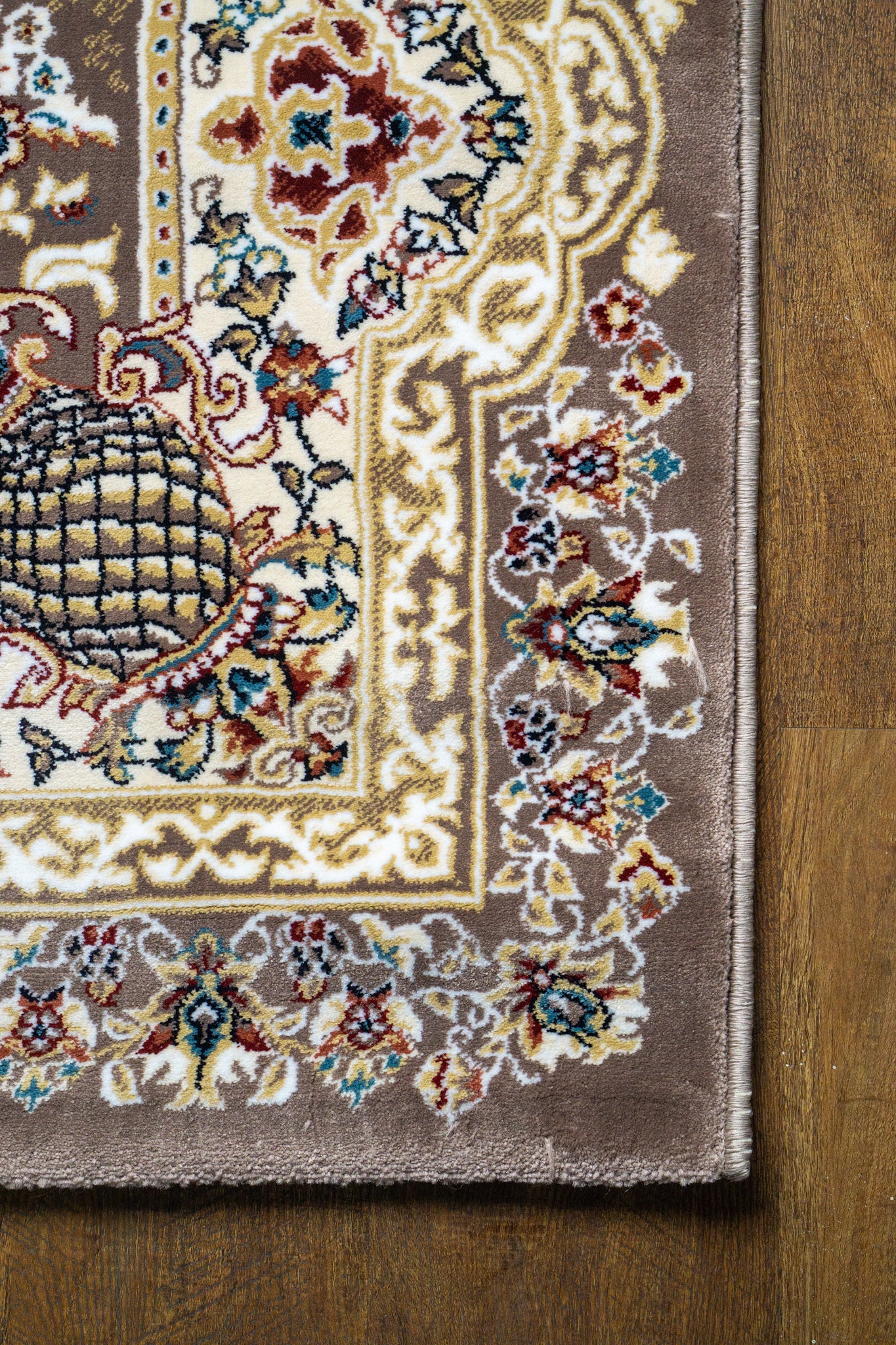 Brown traditional Persian rug with cream medallion and ornate floral borders