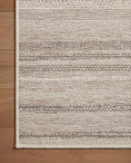 Neutral striped outdoor rug in beige and grey tones on patio