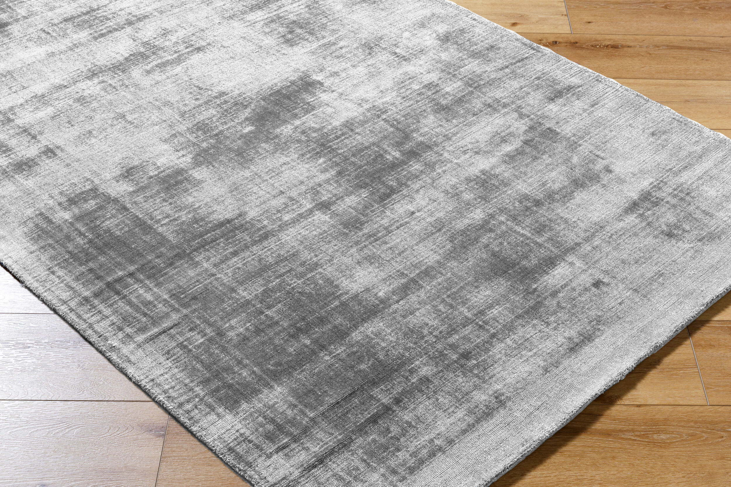 Modern grey abstract textured rug with subtle distressed pattern and soft finish