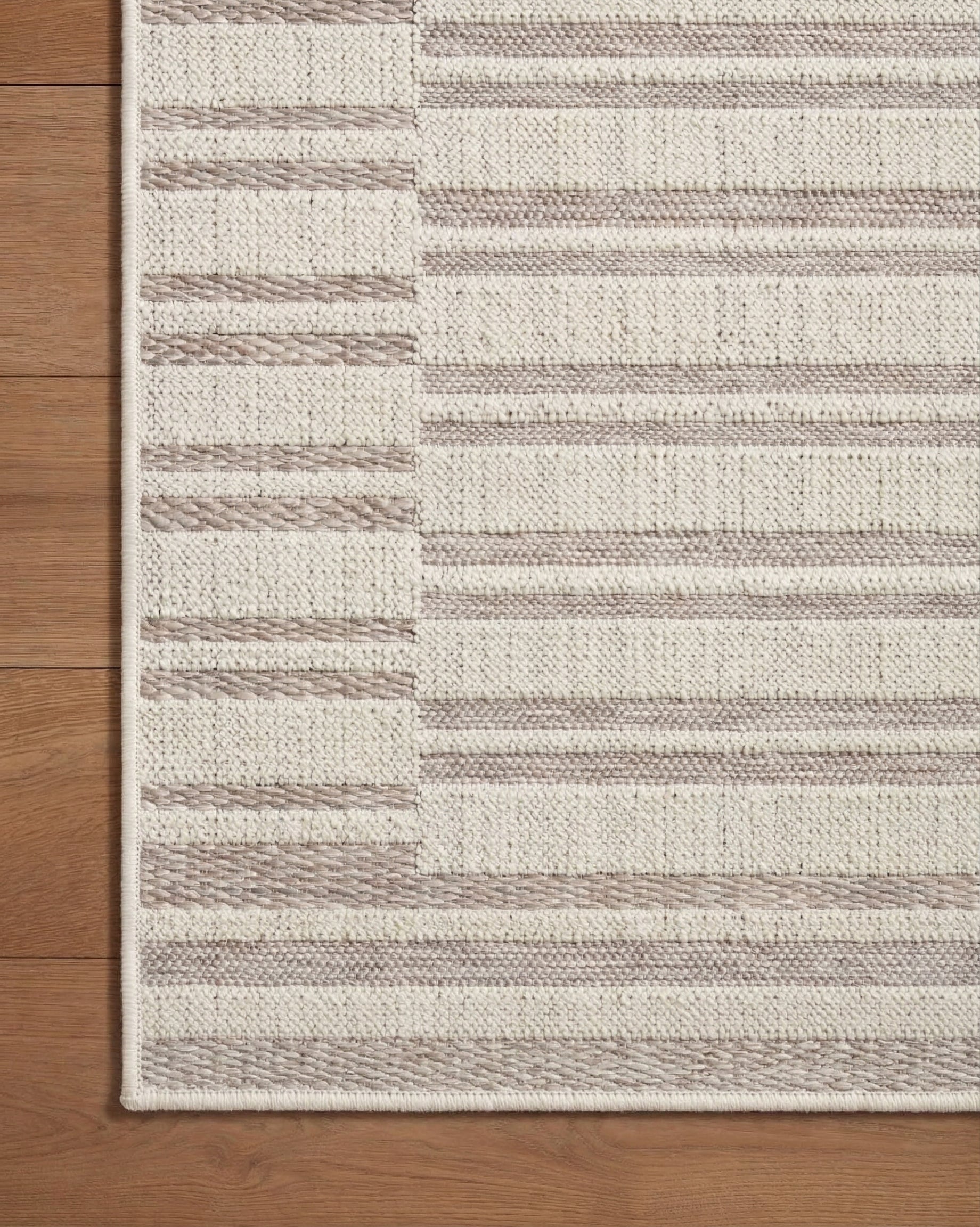 Beige and taupe striped area rug with geometric block pattern design