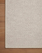 Neutral beige herringbone textured rug with subtle woven pattern throughout
