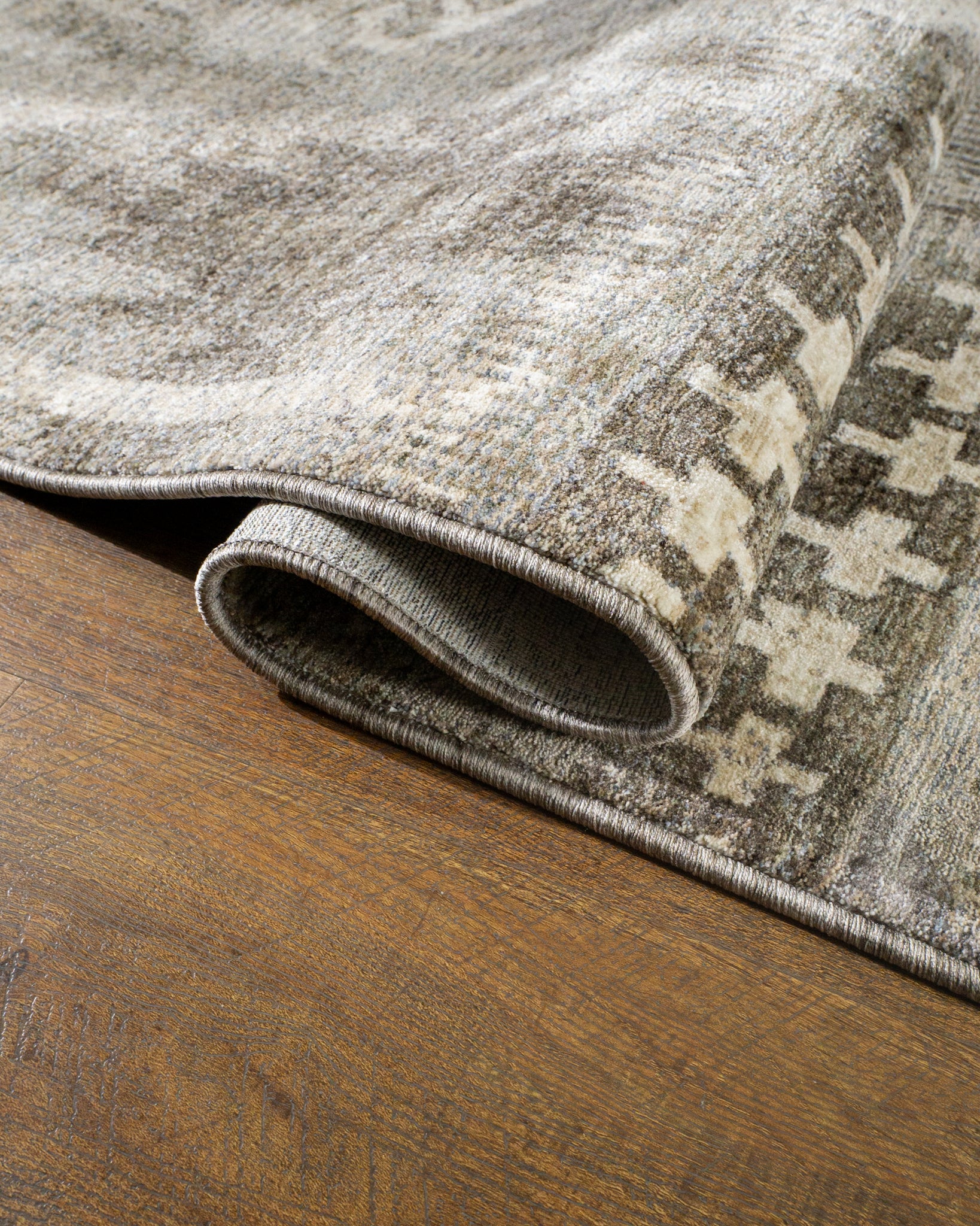 Vintage patchwork rug with geometric patterns in gray and cream tones