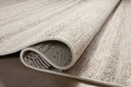 Neutral striped outdoor rug in beige and grey tones on patio