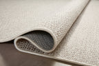 Neutral beige herringbone textured rug with subtle woven pattern throughout
