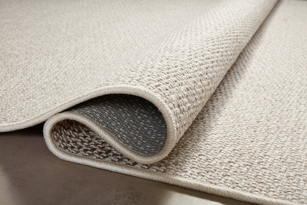 Neutral beige herringbone textured rug with subtle woven pattern throughout