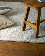 Dark grey to light grey ombre wool rug with speckled texture