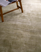 Sage green velvet rug with subtle texture and solid mottled pattern