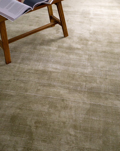 Sage green velvet rug with subtle texture and solid mottled pattern