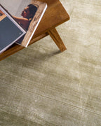 Sage green velvet rug with subtle texture and solid mottled pattern
