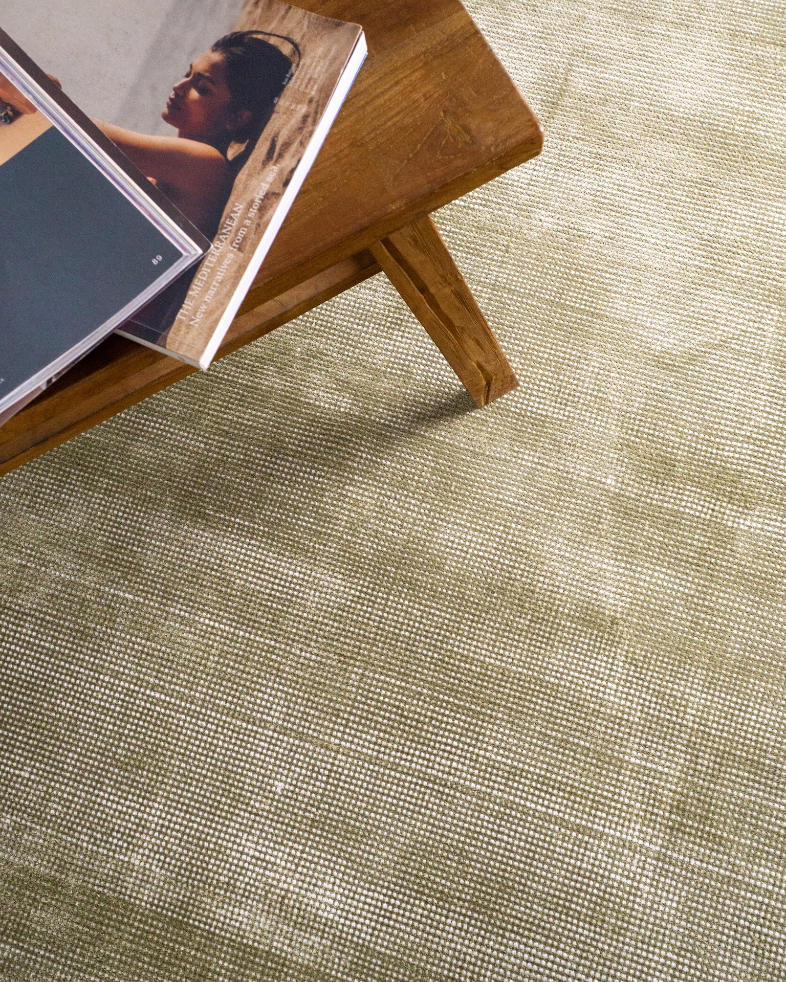 Sage green velvet rug with subtle texture and solid mottled pattern