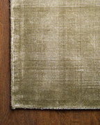 Sage green velvet rug with subtle texture and solid mottled pattern