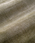 Sage green velvet rug with subtle texture and solid mottled pattern