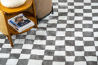 Charcoal and cream checkered wool rug with textured woven pattern