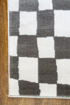 Charcoal and cream checkered wool rug with textured woven pattern