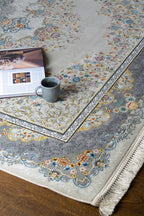 Ornate traditional rug with blue and cream floral medallion pattern and detailed border
