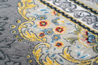 Ornate traditional rug with blue and cream floral medallion pattern and detailed border