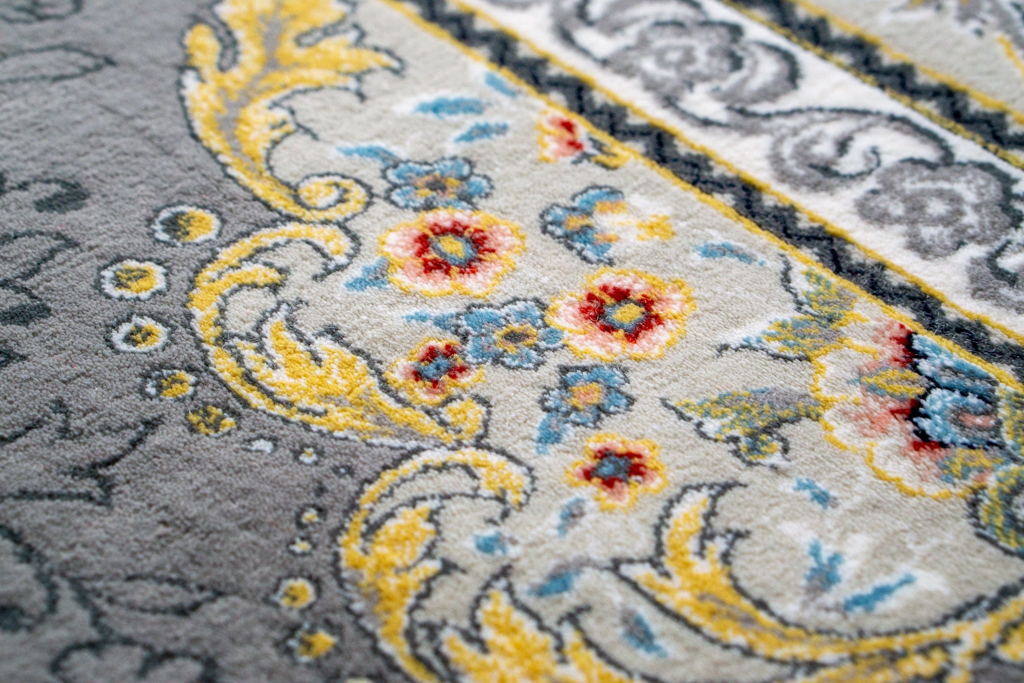 Ornate traditional rug with blue and cream floral medallion pattern and detailed border