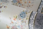 Ornate traditional rug with blue and cream floral medallion pattern and detailed border