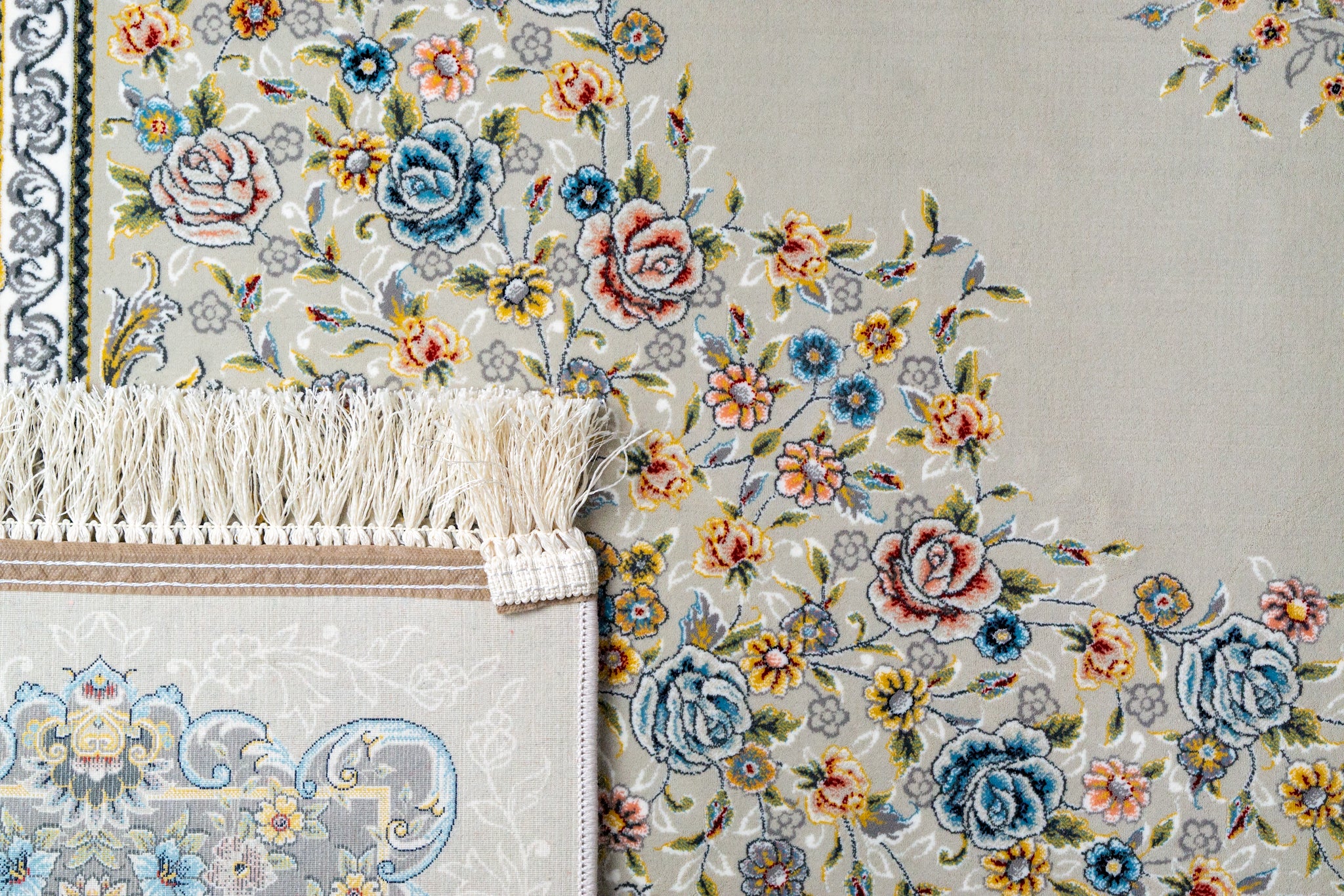 Ornate traditional rug with blue and cream floral medallion pattern and detailed border