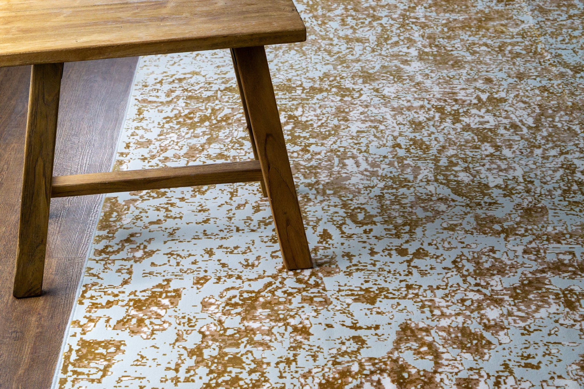 Light blue and gold distressed texture rug with vintage worn pattern