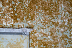 Light blue and gold distressed texture rug with vintage worn pattern