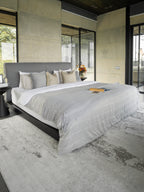 Distressed grey and white rug with abstract speckled texture and worn finish