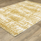 Gold and white distressed texture rug with abstract horizontal pattern