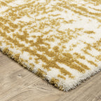 Gold and white distressed texture rug with abstract horizontal pattern