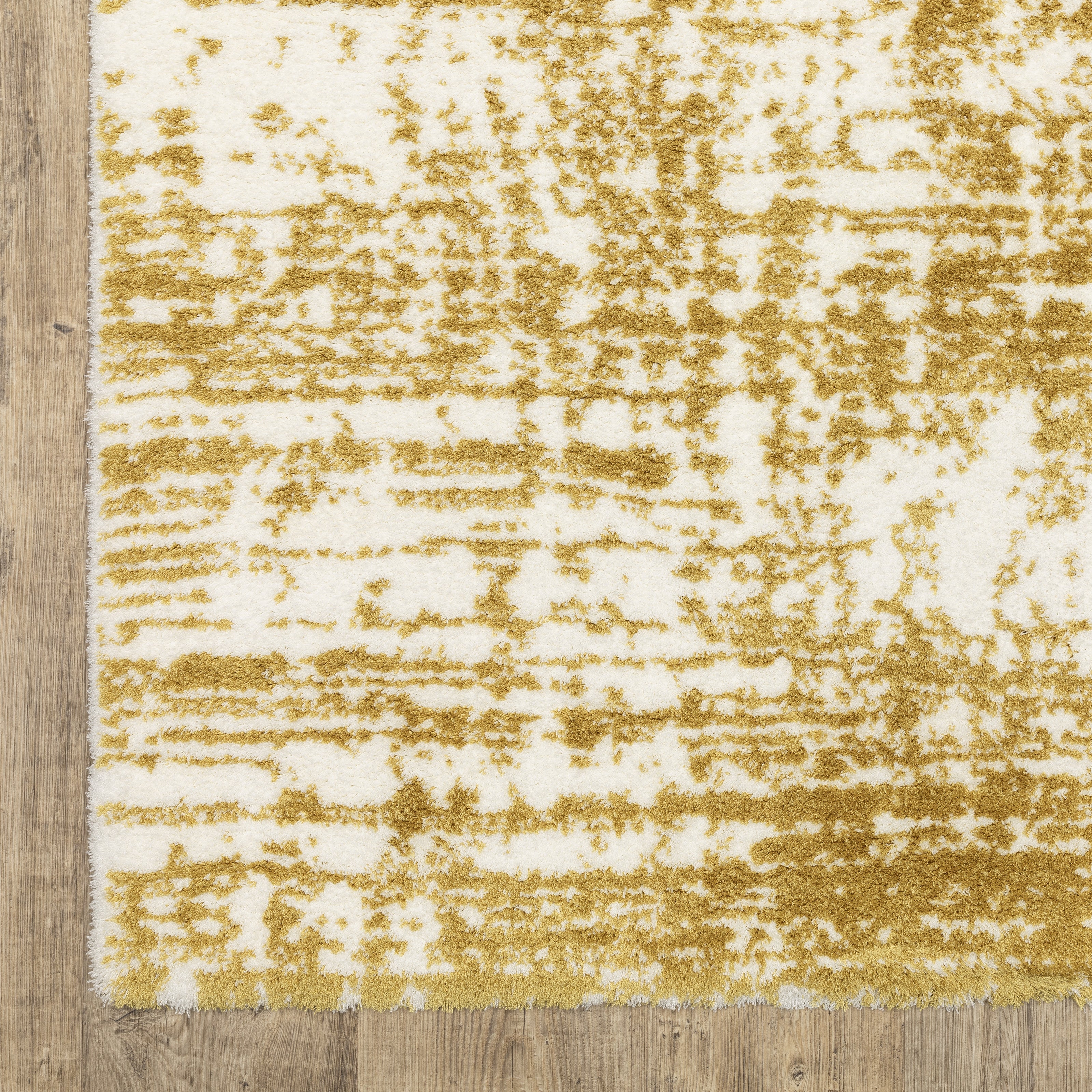 Gold and white distressed texture rug with abstract horizontal pattern