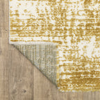Gold and white distressed texture rug with abstract horizontal pattern