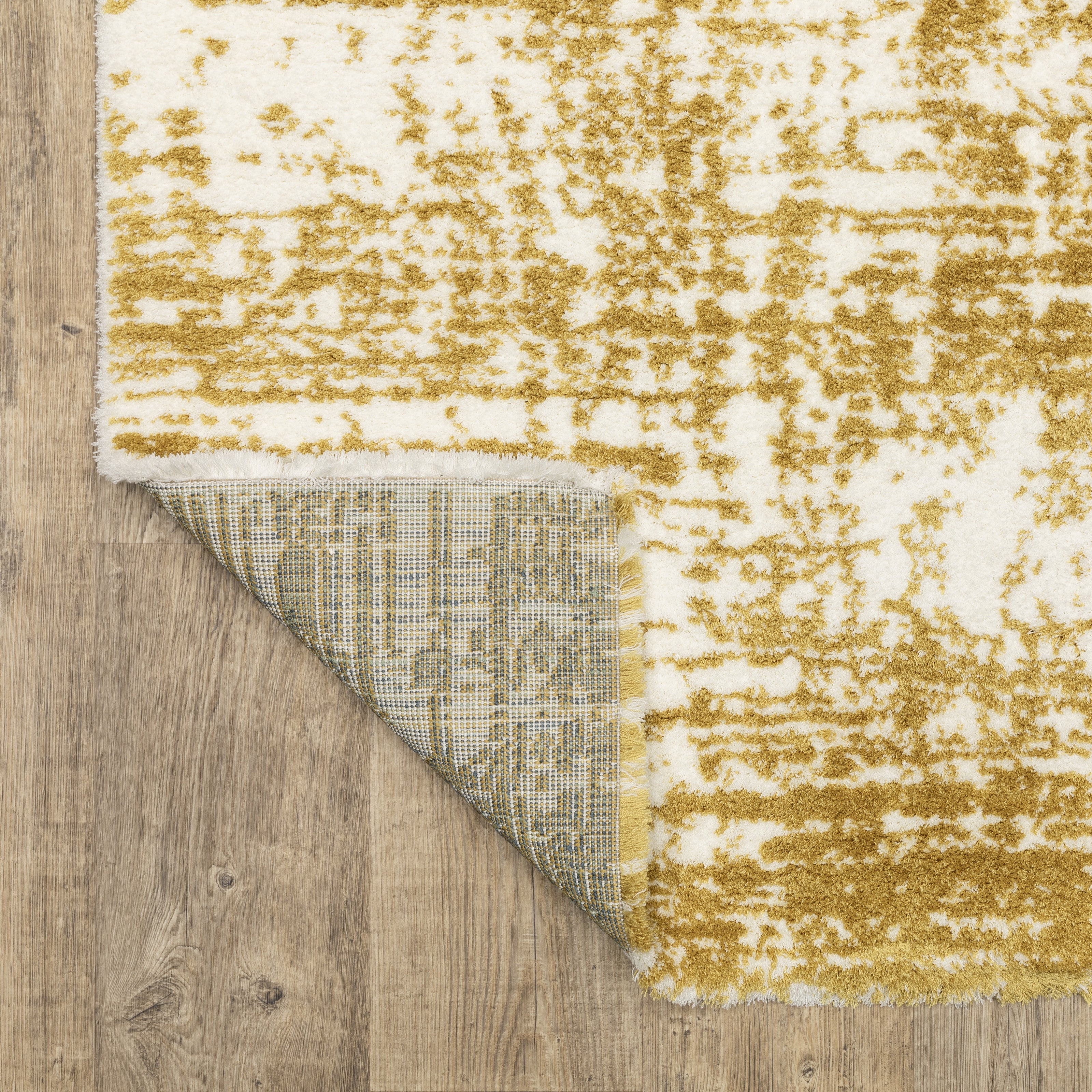 Gold and white distressed texture rug with abstract horizontal pattern