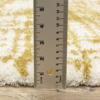 Gold and white distressed texture rug with abstract horizontal pattern