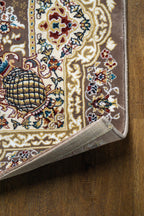 Brown traditional Persian rug with cream medallion and ornate floral borders